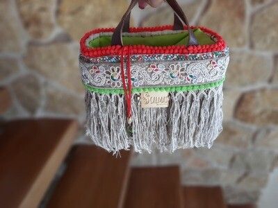 Mini basket with fabric closure and fringes