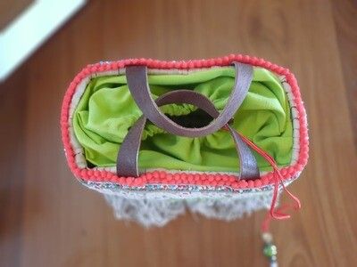 Mini basket with fabric closure and fringes